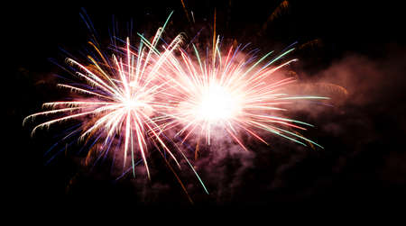 Festive celebration firework lights in the dark night skyの写真素材