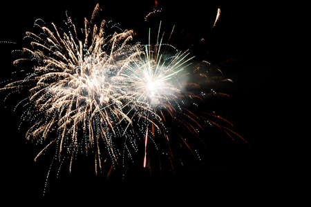 Festive celebration firework lights in the dark night skyの写真素材