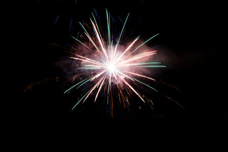 Festive celebration firework lights in the dark night skyの写真素材