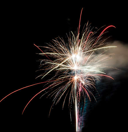 Festive celebration firework lights in the dark night skyの写真素材