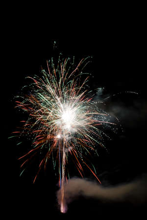 Festive celebration firework lights in the dark night skyの写真素材
