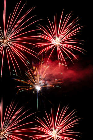 Festive celebration firework lights in the dark night skyの写真素材