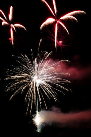 Festive celebration firework lights in the dark night skyの写真素材