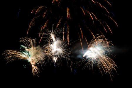 Festive celebration firework lights in the dark night skyの写真素材