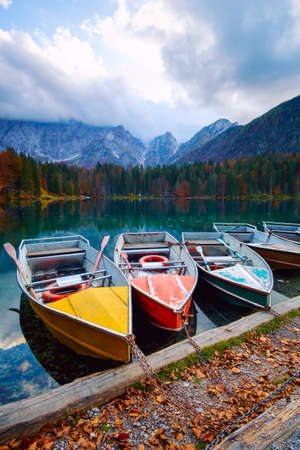 Alpine lake and colorful boats near Slovenian-Italy border, Lake Fusine,Italyの写真素材