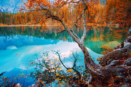 Autumn scenery at lake Fusine - Lago di Fusine-mountain lake in north Italy in the Alps.