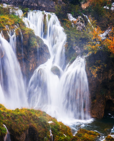 Scenic Autumn Waterfall in Serene Forest Setting of Plitvice Lakes National Parkの写真素材