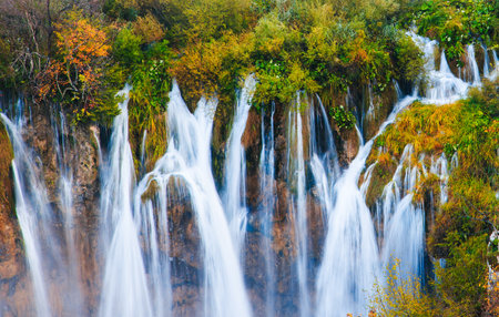 Scenic Autumn Waterfall in Serene Forest Setting of Plitvice Lakes National Parkの写真素材