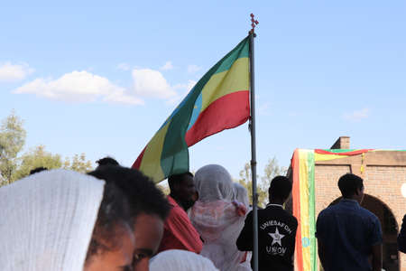 January 19, 2019: a group of unidentified people with a flag dressed in traditional attire during the Timkat holiday, the important Ethiopian Orthodox celebration of Epiphanyのeditorial素材