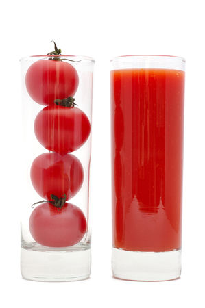 Cherry tomatoes inside of a glass and tomato juice. Isolated on whiteの写真素材