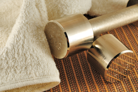 Dumbbells and terry towel on  bamboo matの写真素材