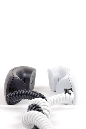Pair of telephone receivers. Black and white. Isolated on whiteの写真素材