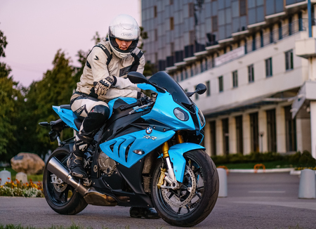 ARKHANGELSK, RUSSIAN FEDERATION - SEPTEMBER 4: Biker on a BMW S 1000 RR sport bike in at sunset, September 4, 2016 at Arkhangelsk, Russian Federation.のeditorial素材