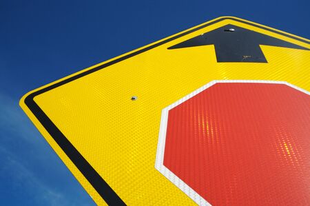 Very Reflective Stop Ahead Sign Abstract on a Blue Skyの写真素材