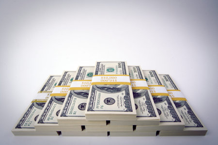 Stacks of Hundred Dollar Bills on a white background.