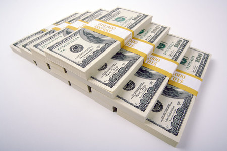Stacks of One Hundred Dollar Bills on a white background.