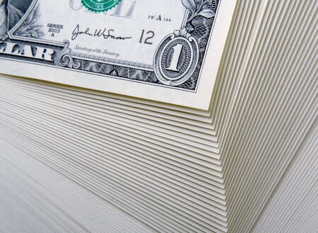Abstract of a stack of one dollar bills.の写真素材