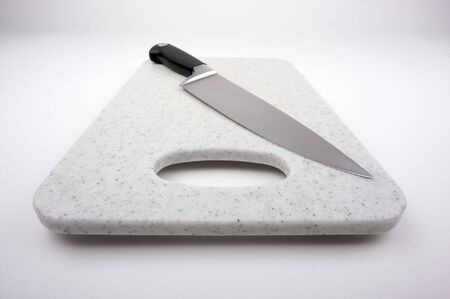 Large Knife on a White Cutting Boardの写真素材