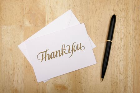 Thank You Note Card and Pen on Wood Backgroundの写真素材
