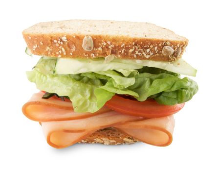 Hearty Sandwich Filled with Vegetables and Sliced Meat Isolated on White.の写真素材