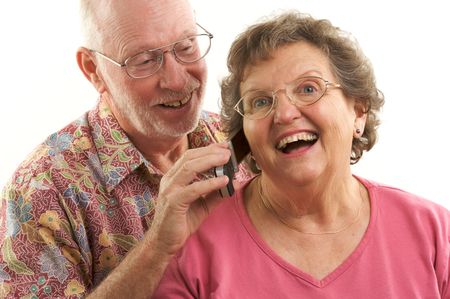 Senior Couple using a cell phone.の写真素材