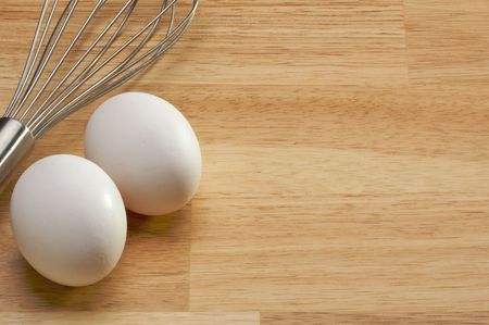 Mixer and Eggs on a wooden background.の写真素材