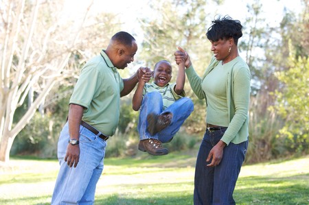 Man, Woman and Child having fun in the park.の写真素材