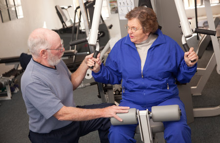 Senior Adult Couple Working Out in the Gym.