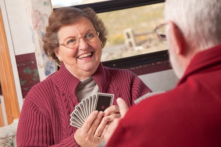 Happy Senior Adult Couple Playing Cards in Their RV.の写真素材