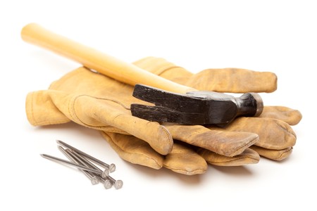 Hammer, Gloves and Nails Isolated on a White Background.の写真素材