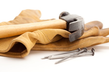 Hammer, Gloves and Nails Isolated on a White Background.の写真素材