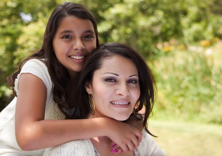 Happy Hispanic Mother and Daughter in the Park.の写真素材