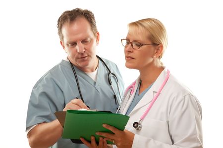 Male and Female Doctors Looking Over Files Isolated on a White Background.の写真素材
