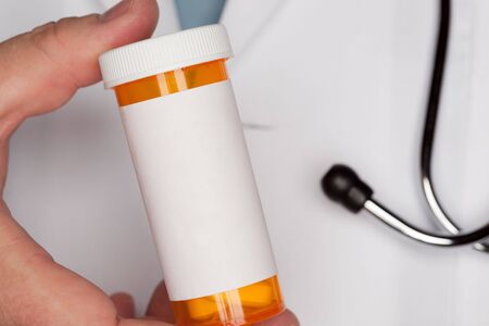 Male Doctor with Stethoscope and Blank Medicine Bottle.の写真素材