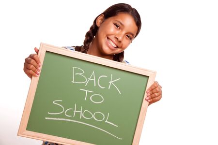 Pretty Hispanic Girl Holding Chalkboard with Back To School Isolated on a White Background.の写真素材
