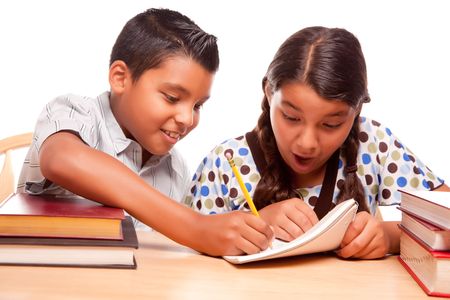 Hispanic Brother and Sister Having Fun Studying Together Isolated on a White Background.の写真素材