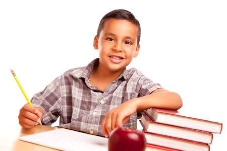 Adorable Hispanic Boy with Books, Apple, Pencil and Paper Isolated on a White Background.の写真素材