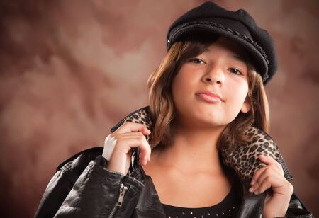 Pretty Hispanic Girl with Hat and Leather Jacket Studio Portrait.の写真素材