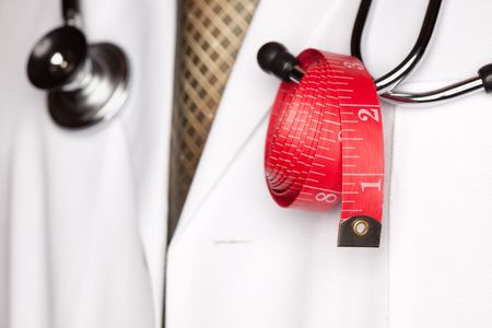 Doctor with Stethoscope and Red Measuring Tape.の写真素材