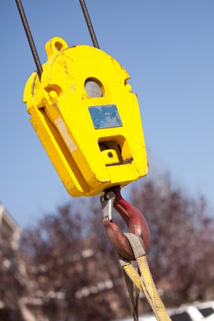Yellow Utility Indutrial Crane Head with Red Hook.の写真素材