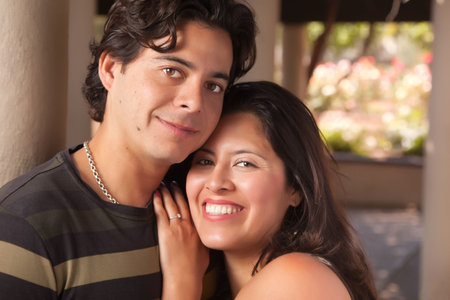 Attractive Hispanic Couple Portrait Enjoying Each Other Outdoors.の写真素材