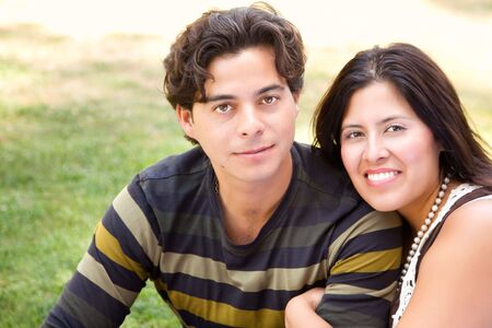 Attractive Hispanic Couple Portrait Enjoying Each Other Outdoors.の写真素材