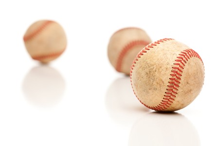 Three Baseballs Isolated on a Reflective White Background.の写真素材
