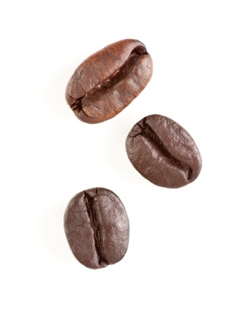 Three Roasted Coffee Beans Isolated on White with Narrow Depth of Field.の写真素材
