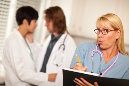 Alarmed Medical Woman Witnesses Her Colleagues Inner Office Romance Display.の写真素材