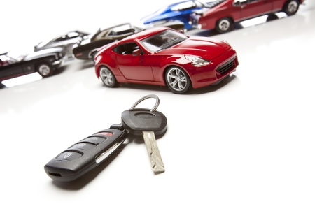 Car Keys and Several Sports Cars on White Background.の写真素材