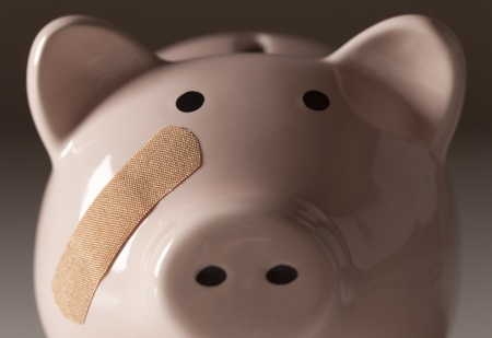 Piggy Bank with Bandage on Face on Gradated Background.の写真素材