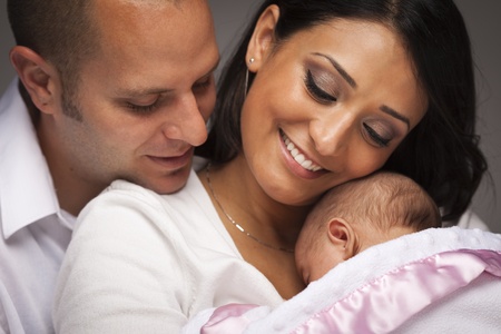 Happy Young Attractive Mixed Race Family with Newborn Baby. Happy Young Attractive Mixed Race Family with Newborn Baby.