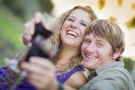 An Attractive Couple Enjoying A Glass Of Wine in the Park Together.の写真素材