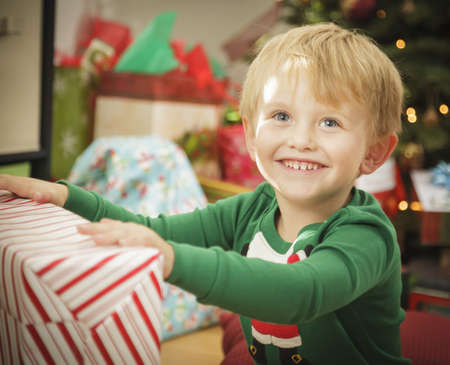 Cute Young Boy Enjoying Christmas Morning Near The Tree.の写真素材